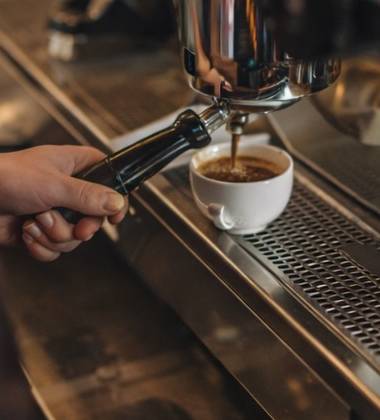Espresso being pulled into a white cup