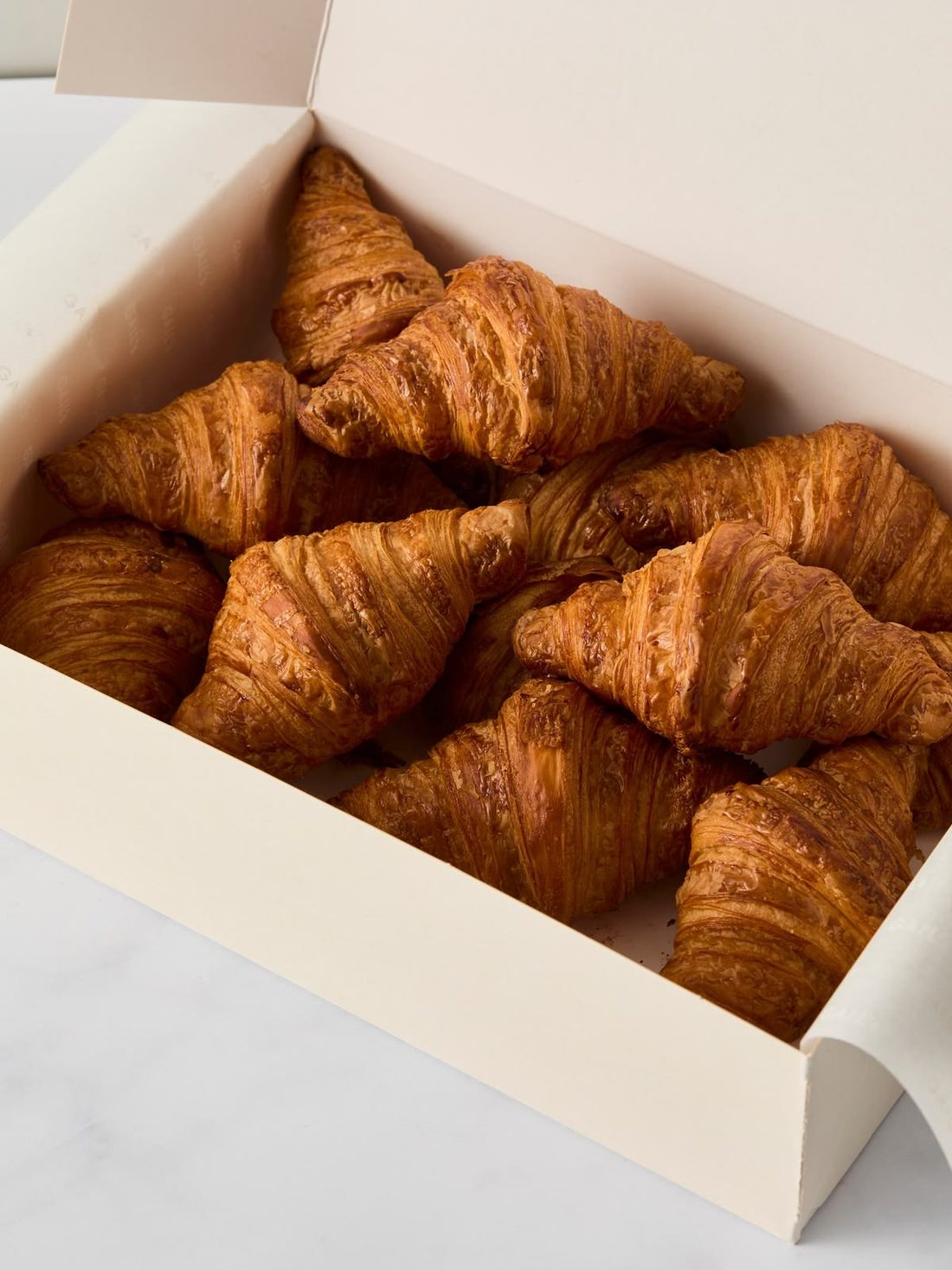 Box of golden butter croissants